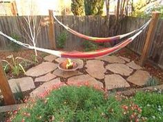 a hammock is in the middle of a garden