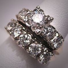 two wedding rings with diamonds on top of each other