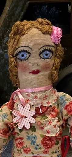 an old doll with blue eyes and red hair