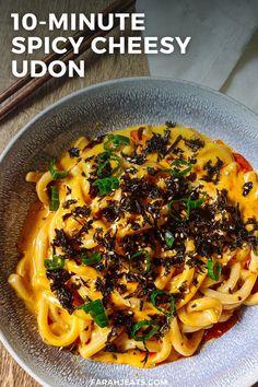 a bowl filled with noodles and sauce on top of a wooden table