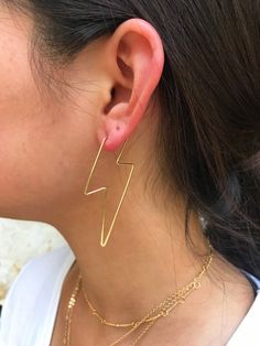 Gold Lightning Bolt Earrings the most PERFECT statement earring EVER! These earrings are one of a kind and is you LOVE to accessorize, these are for you!! Lightning bolts are one of the most trendy accessory shapes and if you love to be bold with your jewelry, here you are! Very high quality gold plating on brass - these earrings are made to last! . . . . . . . . . . . . . . . . . . . . . . . . . . . . . . . . . . . . . . . . . .Measurements: · Size: 60x23mm, Wire 0.9mm thickDetails: · Gold plat Earrings Lightning, Gold Lightning, Bolt Earrings, Wire Hoop Earrings, Lightning Bolt Earrings, Earrings Ideas, Lightning Bolts, Canyon Lake, Diy Wire Jewelry