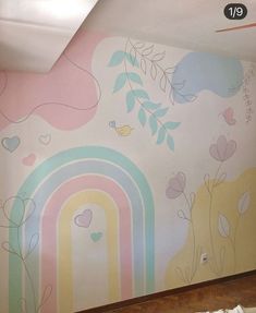 a room with a rainbow painted on the wall