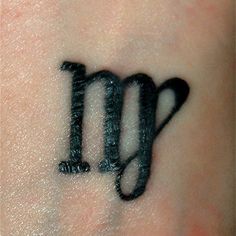 a tattoo with the letter m on it