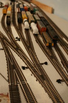 a toy train set with multiple tracks and cars on top of each track, including two trains