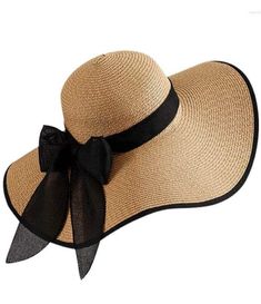 This classic and timeless straw hat is a must-have addition to your wardrobe, offering both style and sun protection. Natural Straw Material: Our hat is crafted from high-quality natural straw, giving it an authentic and beachy vibe. Embrace the beauty of nature with this eco-friendly and sustainable material. Chic Black Trim: The black trim adds a touch of sophistication and contrast to the straw hat, elevating its style to another level. The combination of natural straw and black trim creates Wide Brim Straw Hat, Casual Beach Wear, Form Fitting Dress, Online Clothing Boutiques, Enjoying The Sun, Wide Brimmed Hats, Black Bow, Black Trim, Wide Brimmed