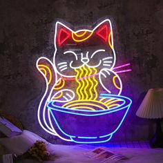 a neon sign that has a cat eating out of a bowl with noodles in it