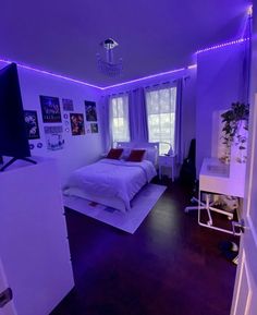 a bedroom with purple lights on the walls