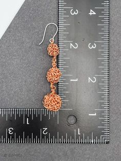 "DON 925's master silversmiths handcrafted these beautiful dangle earrings with copper and sterling silver. The soldering and hook are made of solid 925 sterling silver. Each cluster ball is handmade of copper wire (truly unique!). Length: 6.6 cm (2.60\") Largest ball size: 13 mm (0.50\") Pair weight: 12.7 g (0.44 oz) ★Premium DON925 bag included ★FAQs: https://www.etsy.com/shop/don925#faq ★GET 20% OFF IMMEDIATELY: https://mailchi.mp/998bd2af9c58/don925newsletter ★Instagram @don925newyork ★About Copper Wire Drop Earrings With Matching Set, Copper Wire Dangle Earrings As Gift, Artisan Copper Wire Drop Earrings, Silver Teardrop Jewelry In Copper Wire, Silver Teardrop Jewelry With Copper Wire, Copper Wire Dangle Earrings, Adjustable Copper Wire Pierced Earrings, Artisan Rose Gold Sterling Silver Jewelry, Unique Nickel-free Copper Wire Earrings