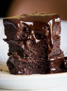 a piece of chocolate cake sitting on top of a white plate