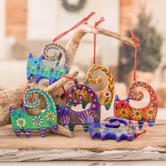 an assortment of colorful wooden ornaments sitting on top of a table