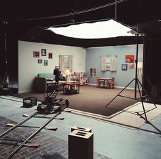 a camera set up in the middle of a room with chairs and other items on the floor