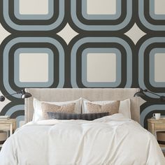 a large bed sitting in front of a wall with circles on it