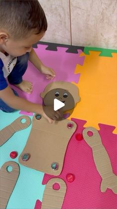 a young boy is making a gingerbread man out of construction paper