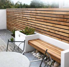 a wooden bench sitting next to a white table