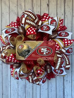 the san francisco cardinals football wreath is made from red and white mesh with polka dots