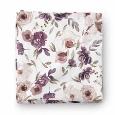 a white sheet with purple flowers on it