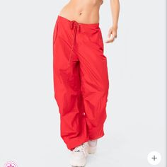 Size Is Xs/S Parachute Pants Drawstring Waistband Drawstring Ankles Cargo Pockets Nylon Model Wears Size Xs/S Model Height Is 5'9 Item Care: Wash With Similar Color Sporty Red Full-length Sweatpants, Red Athleisure Bottoms With Elastic Waistband, Red Sweatpants With Elastic Waistband For Spring, Red Athleisure Bottoms For Streetwear, Sporty Red Pants With Elastic Waistband, Sporty Red Wide Leg Sweatpants, Trendy Fitted Solid Parachute Pants, Trendy Fitted Solid Color Parachute Pants, Spring Red Sweatpants For Streetwear