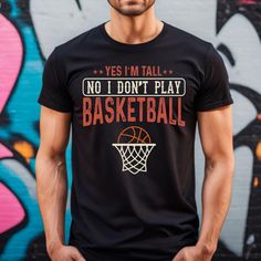 Make a Statement with our Beautiful and Retro Unisex Funny and Cute Basketball T-shirt "Yes i'm tall no i don't play basketball". This Vintage looking shirt is the best gift, Could be a perfect Tshirt gift for Mom, Dad, and Friends on any occasion. Our  Relaxed Fit Tee is a unisex design that runs slightly small for men and approximately half a size bigger for women. This t-shirt has a comfortable, relaxed fit and is made from soft, cozy material. * For T-shirt Sizes Please refer to the Listing Cute Basketball Shirt For Boyfriend, Black Tops With Lettering For Sports Events, Black Tops With Team Spirit Lettering, Cotton Slogan Top For Sports Events, Cotton Tops With Lettering For Sports Events, Coach Basketball, Basketball Hoodie, Play Basketball, Tall Person