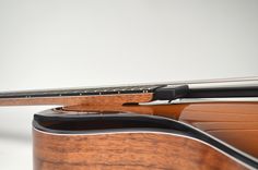 a close up of an acoustic guitar's fret and case on a white background