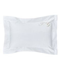 the embroidered monogrammed pillowcase is white and has gold lettering that reads f