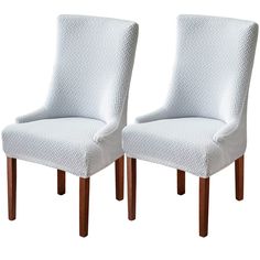 pair of white upholstered chairs with wood legs