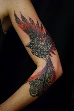 a woman's arm with an intricate tattoo design on her left arm and shoulder