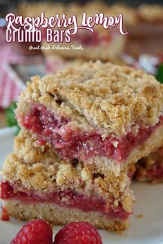 two strawberry crumb bars stacked on top of each other in front of a plate