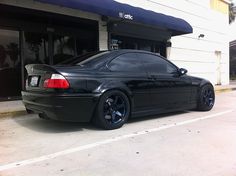 a black car parked in front of a building