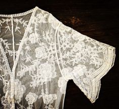 "This overlayering piece is made with soft embroidered sheer lace, features mid sleeve with scalloped sleeve edge and hem. Makes for a super sweet cover up for any outfit! ONE SIZE FITS MOST - SMALL, MEDIUM, LARGE Length: 37\" Bust: 23\" (open front, one size fits all) Armhole: 11\" Now when you order two items or more, your shipping is on us! Enter FREESHIP at checkout! ( US shipping only) And/Or Share your photo with me in the item you purchased, you will receive a $15 coupon toward your next Bohemian Lace Patchwork For Spring, Bohemian Fitted Lace For Spring, Fitted Bohemian Lace For Spring, Fitted Bohemian Kimono For Festivals, Fitted Bohemian Wrap Kimono, Bohemian Summer Lace With Lace Patchwork, Bohemian Lace With Lace Patchwork For Summer, Fitted Summer Kimono With Embroidery, Fitted Summer Embroidered Kimono