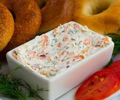 an assortment of bagels and dip on a plate