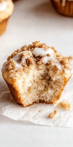 a muffin that has been cut in half and is sitting on some wax paper