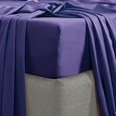 an image of a bed with purple sheets on it