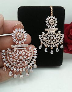 American DIAMOND Rose Gold/ Silver Plated EARRING MANGTIKA set, Indian bridal, Cz Stones Chandbali Earring tika Sabyasachi Designer Jeweller For Women & Girls By Electrifying Jewellery STYLE TIP - These earrings are a perfect accessory to match your daily wear needs. A perfect go to pair for a luncheon with girls, a classic work day or date night. These Combos are based in Rose Gold copper alloy with rhodium plating. Care Tip - 1. Keep away from moisture and perfume 2. Store in cotton or zip loc White Stone Work Chandelier Earrings For Wedding, White Chandelier Earrings With Stone Work For Wedding, Wedding Chandelier Earrings With Cubic Zirconia, Wedding White Hand Set Danglers, Festive Wedding Chandelier Earrings Cubic Zirconia, Festive Wedding Chandelier Earrings, Festive Cubic Zirconia Bridal Earrings For Wedding, Rose Gold Earrings For Wedding And Festive Occasions, Festive American Diamond Bridal Earrings For Wedding