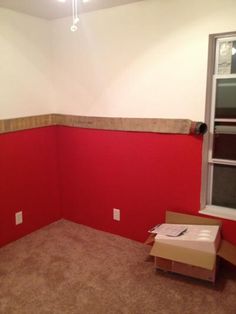 an empty room with red walls and white trim on the wall is being painted in preparation for painting