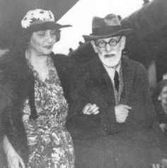 an old black and white photo of two people in hats standing next to each other