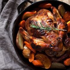 roasted chicken with carrots and potatoes in a cast iron skillet