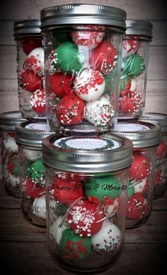 some glass jars filled with red and green ornaments