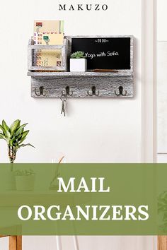 mail organizer hanging on the wall next to a potted plant and desk with notepads