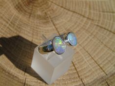 Open ended silver ring with 2 Coober Pedy opals. Both opals have beautiful bright yellow, green, blue and purples. One is approximately 0.8ct and 8x6mm, the other 1ct and 9x6mm. Size S UK/Aus, 9.25US, plain band, 4.5mm width. As ring is open ended there is some variation on size available. Handmade Opal Open Ring Gift, Handmade Opal Open Ring For Gift, Handmade Open Opal Ring For Gift, Adjustable Opal Ring, Handmade Open Opal Ring, Nickel-free Adjustable Opal Rings, Unique Adjustable Opal Gift Ring, Handmade Opal Crystal Ring As Gift, Nickel-free Opal Rings As Gifts