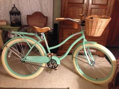 a blue bicycle parked in front of a dresser