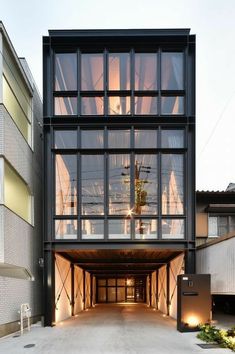 the entrance to an apartment building is lit up by lights on either side of it