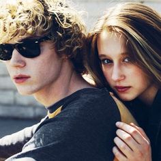 a young man and woman sitting next to each other