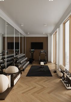 an empty gym with mirrors and treadmills