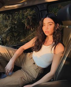 a woman sitting in the back seat of a car