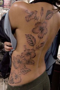 a woman with a flower tattoo on her back