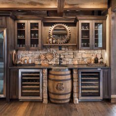 a wine barrel in the middle of a kitchen with wooden floors and cabinets around it