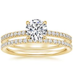 a yellow gold engagement ring and wedding band set with a round cut diamond in the center