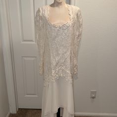 Off White Dress Floor Length In The Back Front Is Below The Knee. Top Of Dress Is Lace Over Fabric With Sleeves See Through Lace Round Neck All Accented With Flowers Omgosh So Pretty!! The Details Are Amazing! No Bead Work! Nadine Boutique 15/16 Elegant Long Sleeve Wedding Dress With Lace Trim, Long Sleeve Lace Dress With Fitted Bodice For Wedding, Formal Wedding Dress With Lace Trim And Fitted Bodice, Long Sleeve Scalloped Lace Wedding Dress, White Wedding Dress With Lace Trim For Formal Occasion, Formal White Wedding Dress With Lace Trim, Formal White Long Sleeve Mother Of The Bride Dress, Formal White Gown With Scalloped Lace, White Lace Sleeves Evening Dress For Wedding