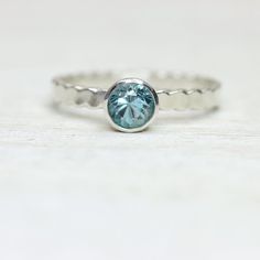 Natural zircon is such a stunning and brilliant stone. This silver ring holds a bright, sparkling, 5mm sky blue zircon, on a simple and elegant band. Stack it with your other favorite rings, or wear it on its own. Please remember to include your ring size at checkout! Sterling Silver Solitaire Topaz Promise Ring, Minimalist Aquamarine Promise Ring, Turquoise Topaz Ring In Sterling Silver, Sterling Silver Ring With Light Blue Center Stone, Dainty Solitaire Topaz Ring In Sterling Silver, Minimalist Solitaire Topaz Ring In Sterling Silver, Minimalist Sterling Silver Solitaire Topaz Ring, Silver Topaz Solitaire Birthstone Ring, Silver Solitaire Topaz Birthstone Ring