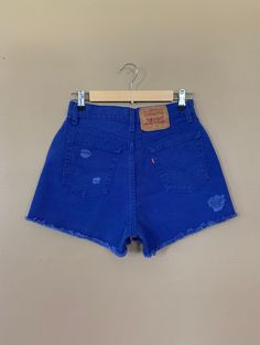 "High waisted 90's denim shorts. Made by Levi's in rare bright blue denim wash. Shorts are in excellent clean condition. Brand new with tags before I made them into cutoff shorts. These have been cutoff, distressed by hand, and washed once. Measurements are taken zipped or buttoned up and laid comfortably flat then x 2 for total circumference (inches) Tag Size 7 Levi's 560 100% Cotton Made in USA Waist 28\" Hips 42\" Length 13.5\" Inseam 2.5\" Rise 12\" leg opening circumference 26\" All items a 90s Denim Bottoms With Frayed Hem, High-rise 90s Style Summer Bottoms, 90s Style High Rise Summer Bottoms, Retro Cutoff Bottoms For Summer, High Rise Jean Shorts For Summer In 90s Style, 90s Inspired Cutoff Bottoms For Summer, 90s Inspired High Rise Jean Shorts For Summer, 90s Style Dark Wash Bottoms For Spring, Blue Distressed Shorts For Summer